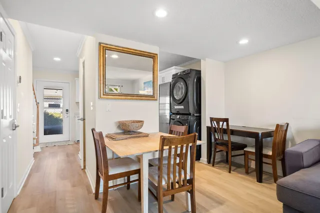 a bedroom with a bed and a chair with the wooden floor