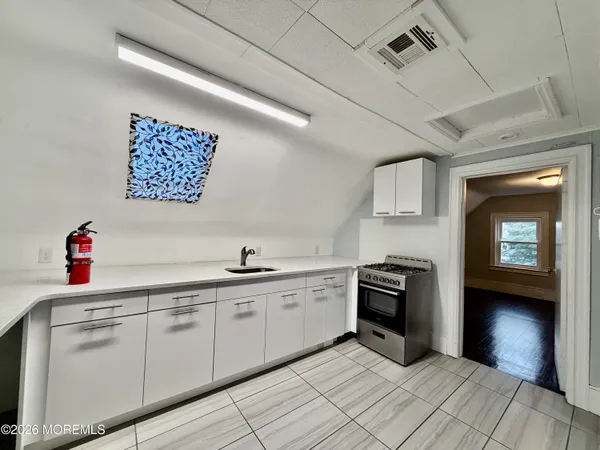 a kitchen with a sink cabinets and appliances
