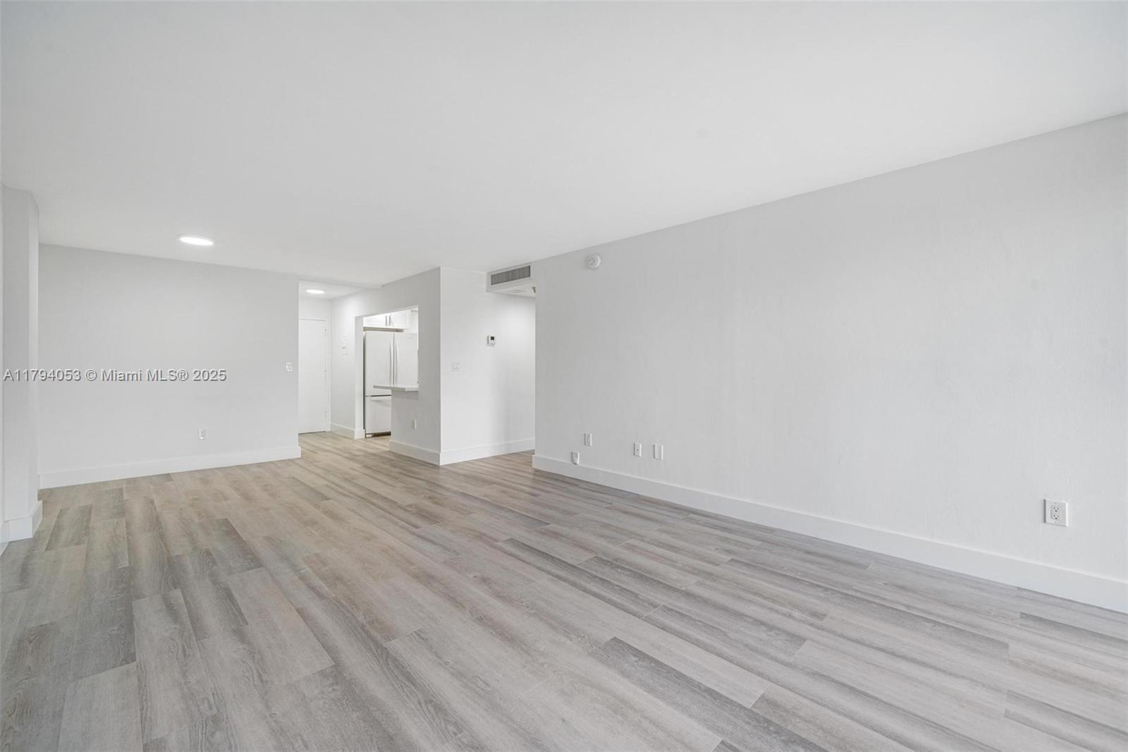 150 Southeast 25th Road, Unit 2H Miami, FL 33129 - Photo 2 of 15 a view of an empty room and wooden floor