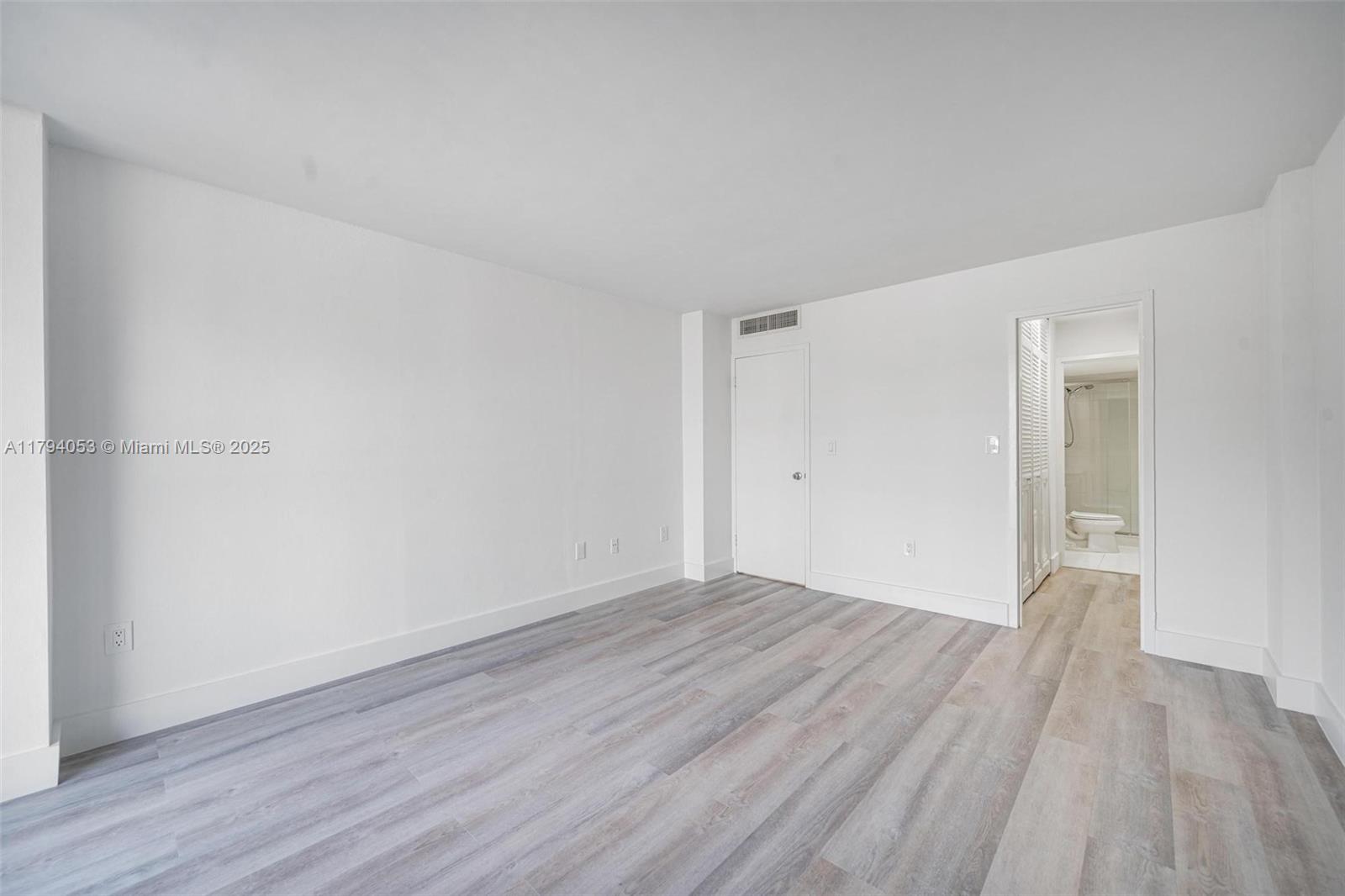 150 Southeast 25th Road, Unit 2H Miami, FL 33129 - Photo 7 of 15 a view of an empty room with wooden floor