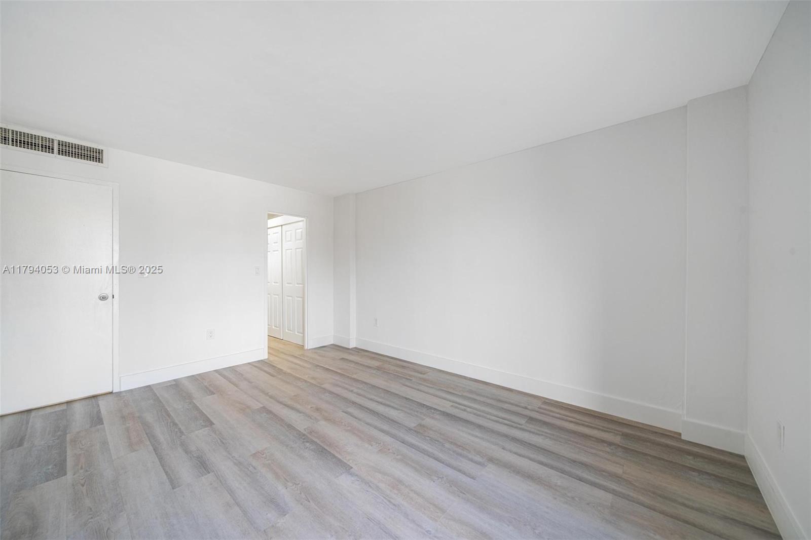 150 Southeast 25th Road, Unit 2H Miami, FL 33129 - Photo 8 of 15 a view of an empty room with wooden floor