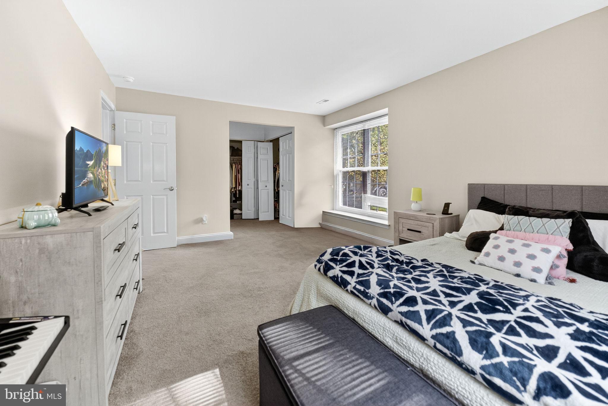 22 Meadow Lane New Hope, PA 18938 - Photo 12 of 21 a bedroom with a large bed and a flat screen tv