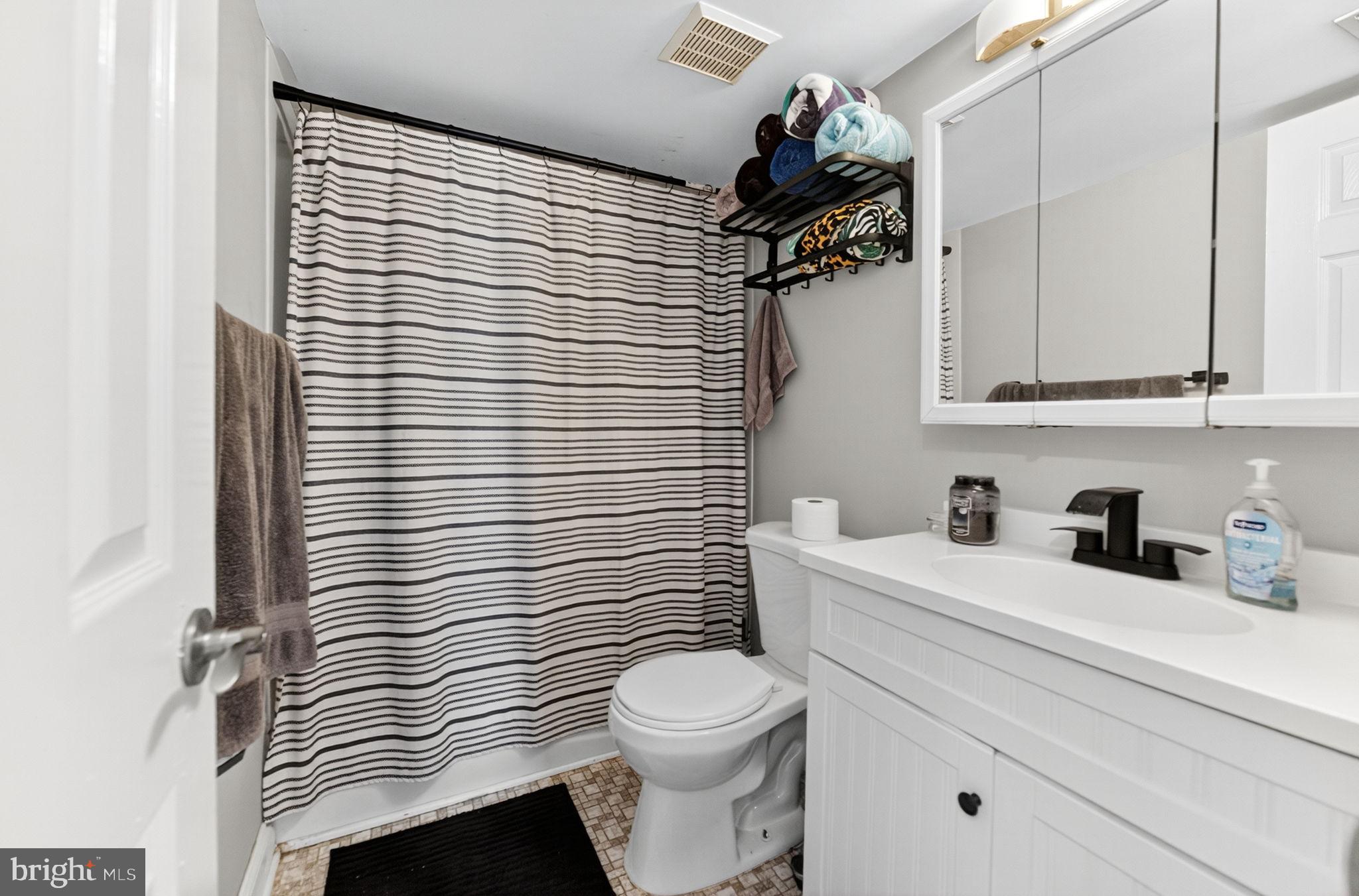 22 Meadow Lane New Hope, PA 18938 - Photo 15 of 21 a bathroom with a sink a toilet and shower curtain
