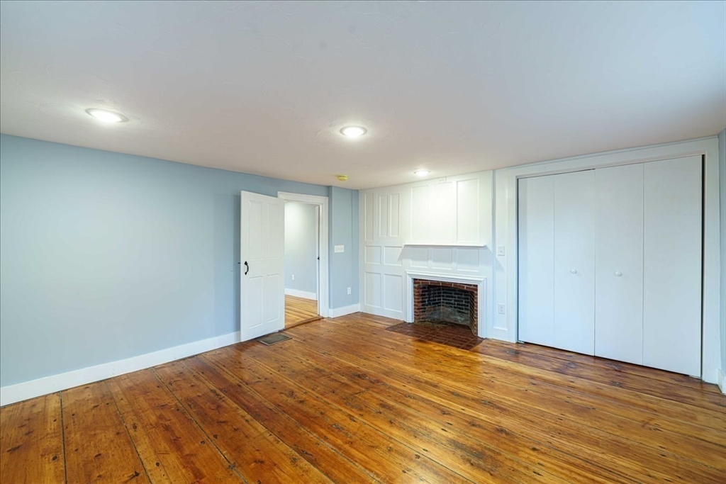 42 Silver Hill Road Milford, MA 01757 - Photo 13 of 30 a view of empty room with wooden floor and fireplace