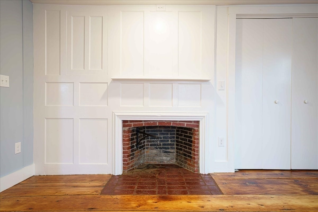 42 Silver Hill Road Milford, MA 01757 - Photo 14 of 30 a view of an empty room with wooden floor and a fireplace