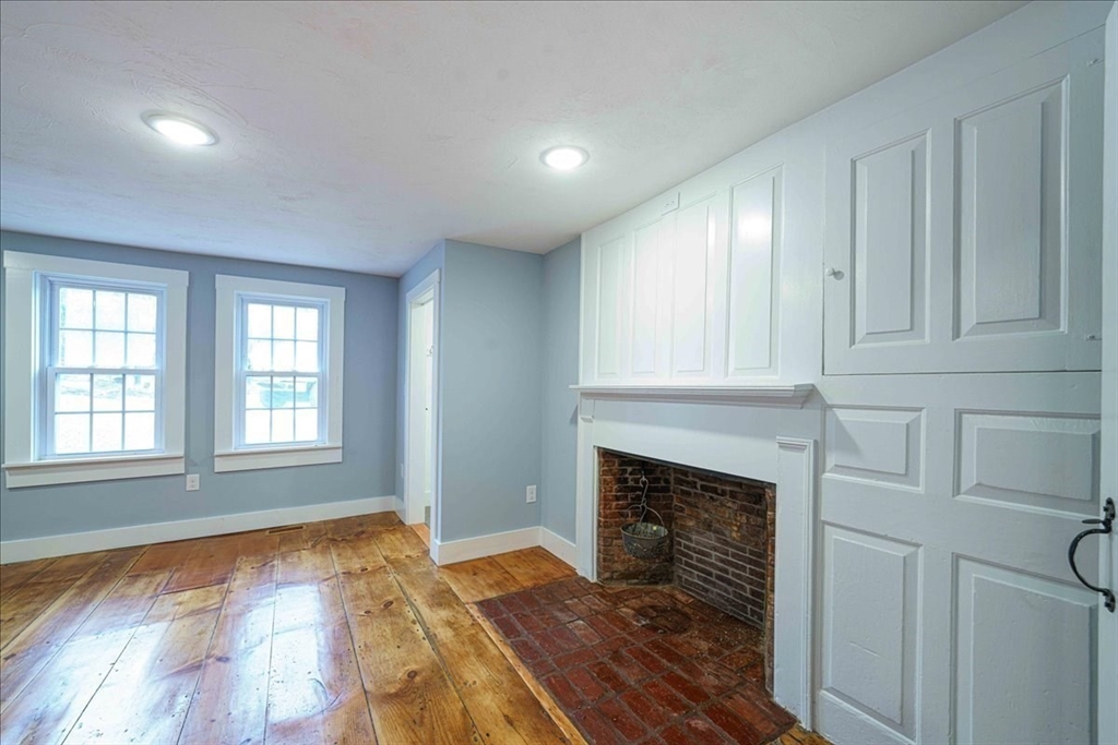 42 Silver Hill Road Milford, MA 01757 - Photo 15 of 30 an empty room with wooden floor fireplace and windows