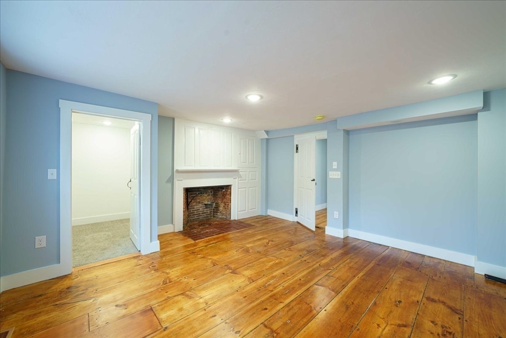 42 Silver Hill Road Milford, MA 01757 - Photo 16 of 30 a bedroom with a bed and a fireplace