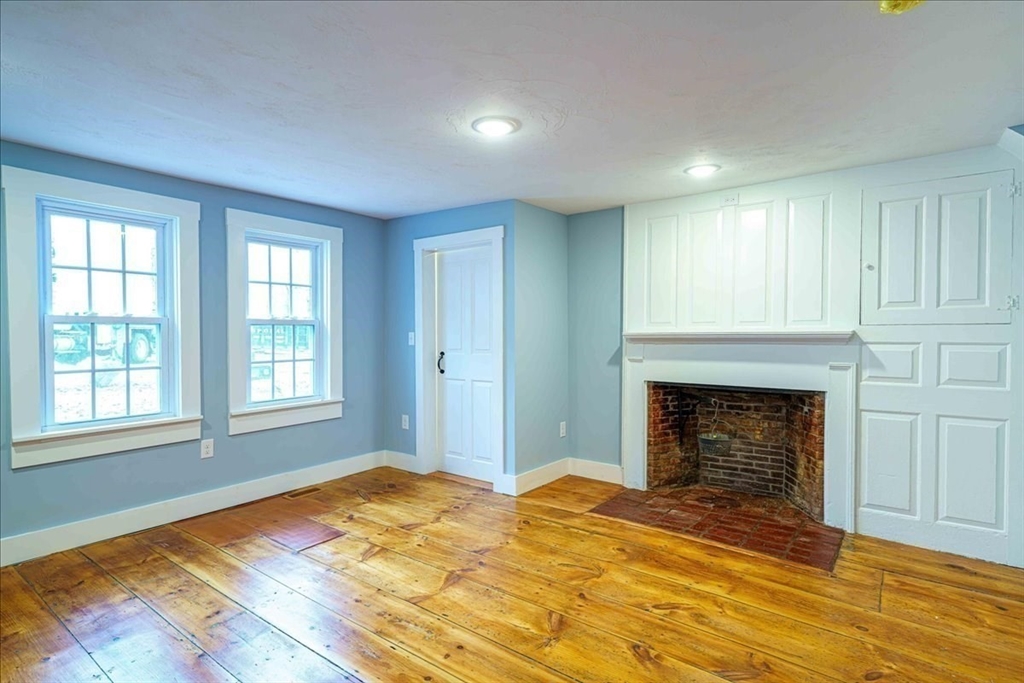 42 Silver Hill Road Milford, MA 01757 - Photo 17 of 30 a view of empty room with wooden floor and fireplace