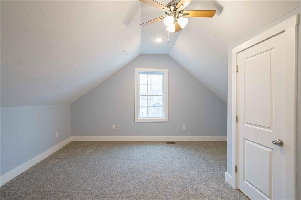 42 Silver Hill Road Milford, MA 01757 - Photo 23 of 30 an empty room with a chandelier fan and windows