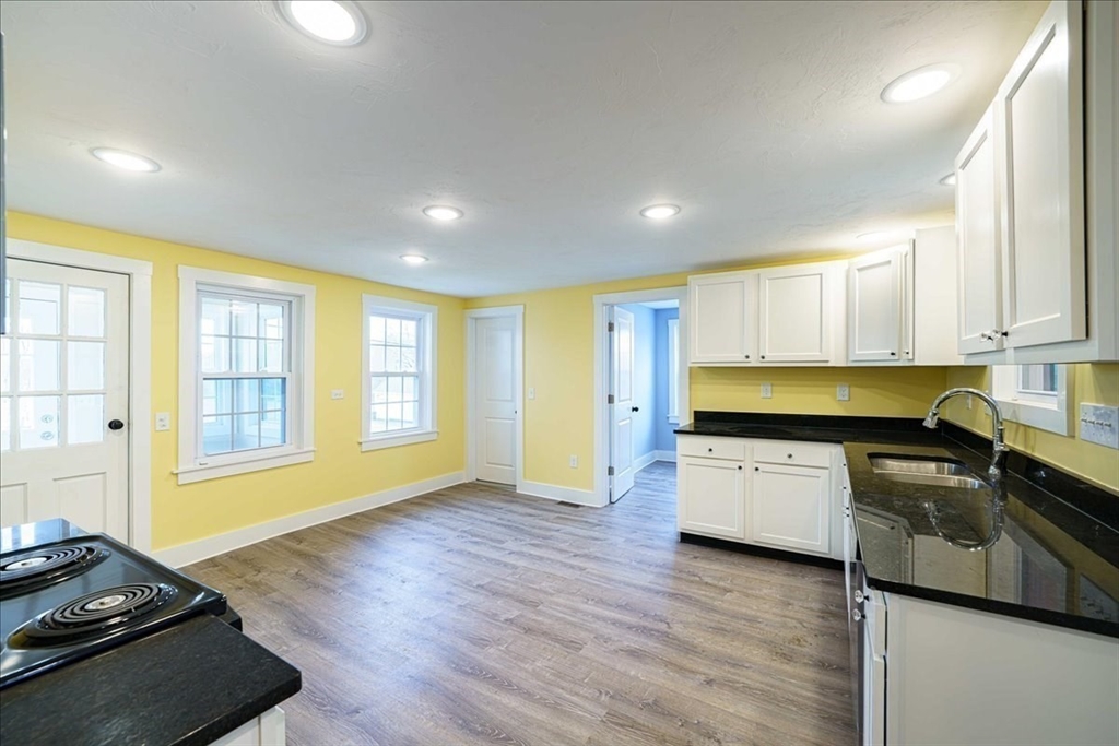 42 Silver Hill Road Milford, MA 01757 - Photo 3 of 30 a kitchen with a stove a sink and a refrigerator