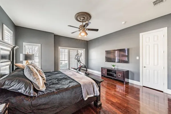 a bedroom with a bed and a chandelier