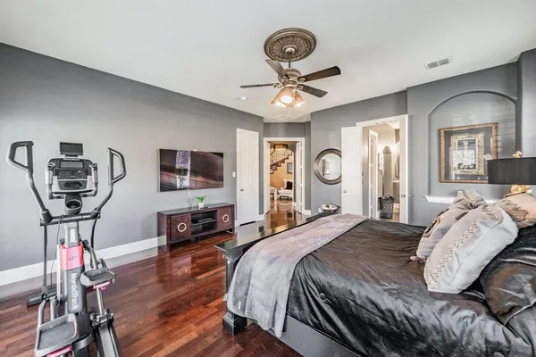 a bedroom with bed and a chandelier