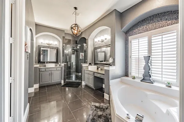 a large bathroom with a large tub and a large window