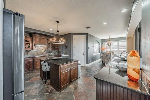 a kitchen with stainless steel appliances granite countertop a stove oven and a refrigerator