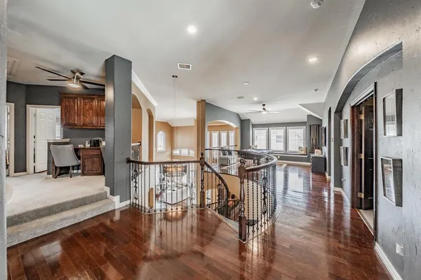 a view of a dining room with furniture a rug and wooden floor