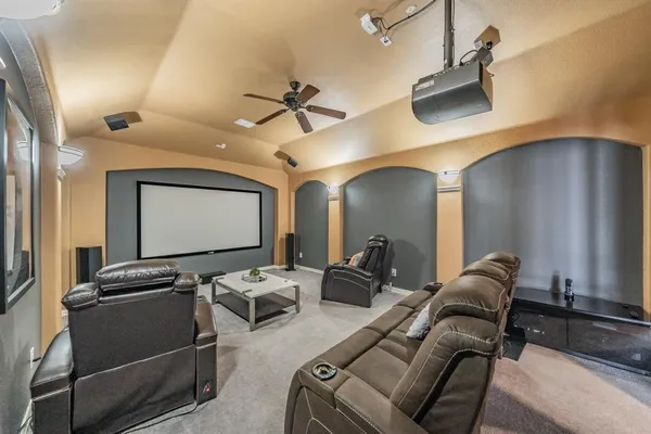 a living room with furniture ceiling fan and a rug