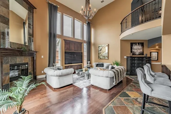 a living room with furniture fireplace and a large window