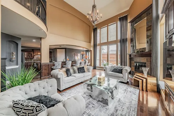 a living room with furniture fireplace and a large window