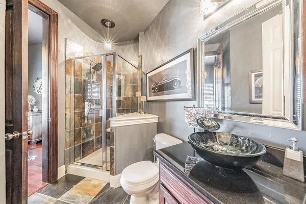 a bathroom with a sink toilet and shower