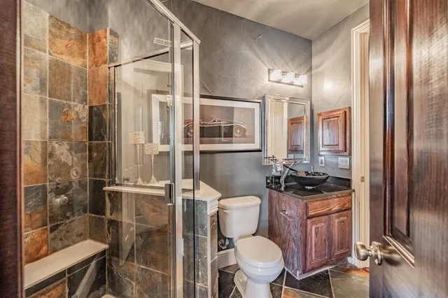 a bathroom with a toilet a sink and shower