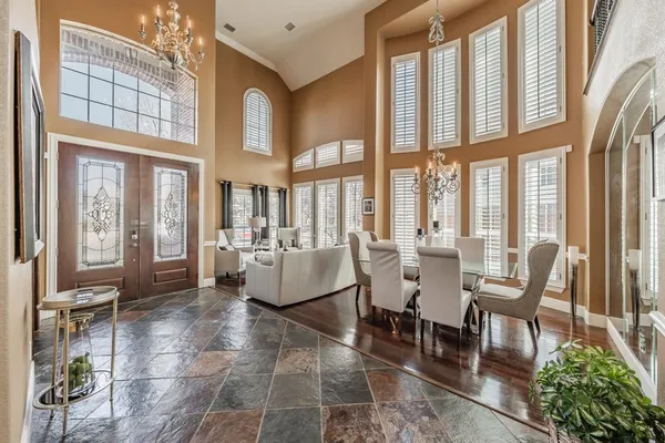a living room with furniture and floor to ceiling windows