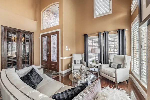 a living room with furniture and large windows