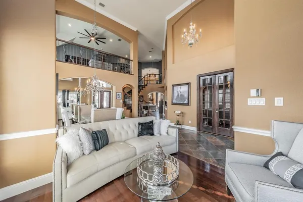 a living room with furniture and a chandelier