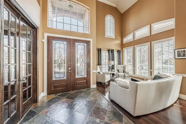 a living room with furniture and large windows