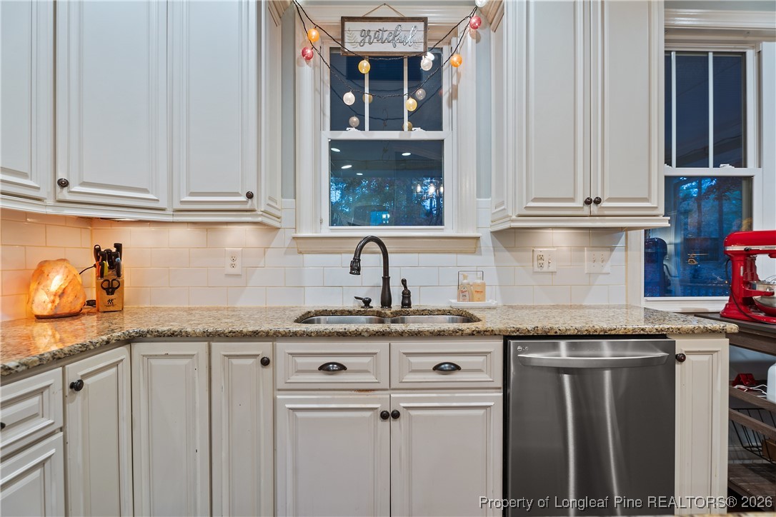 38 Overview Court Spring Lake, NC 28390 - Photo 11 of 50 a kitchen with granite countertop a sink and cabinets