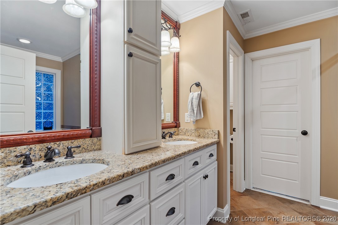 38 Overview Court Spring Lake, NC 28390 - Photo 22 of 50 a bathroom with a granite countertop double vanity sink and a mirror