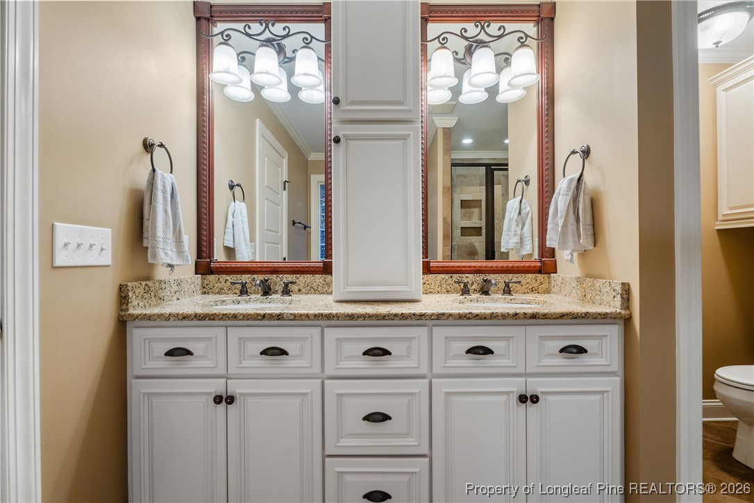 38 Overview Court Spring Lake, NC 28390 - Photo 23 of 50 a bathroom with a double vanity sink and a mirror