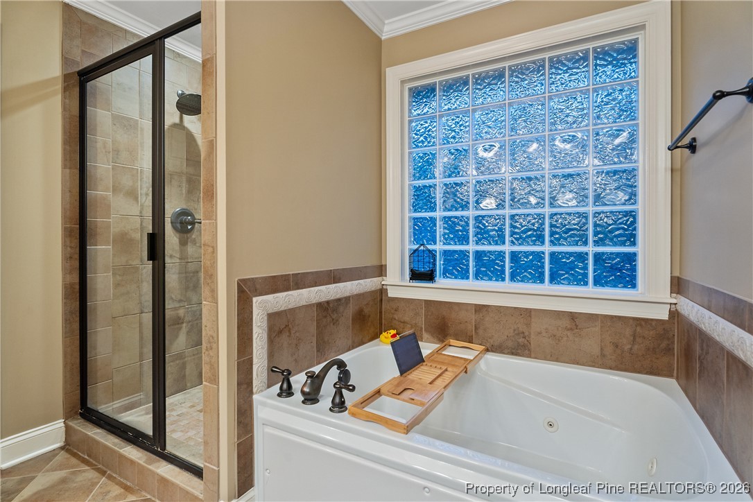 38 Overview Court Spring Lake, NC 28390 - Photo 24 of 50 a bathroom with a tub and shower