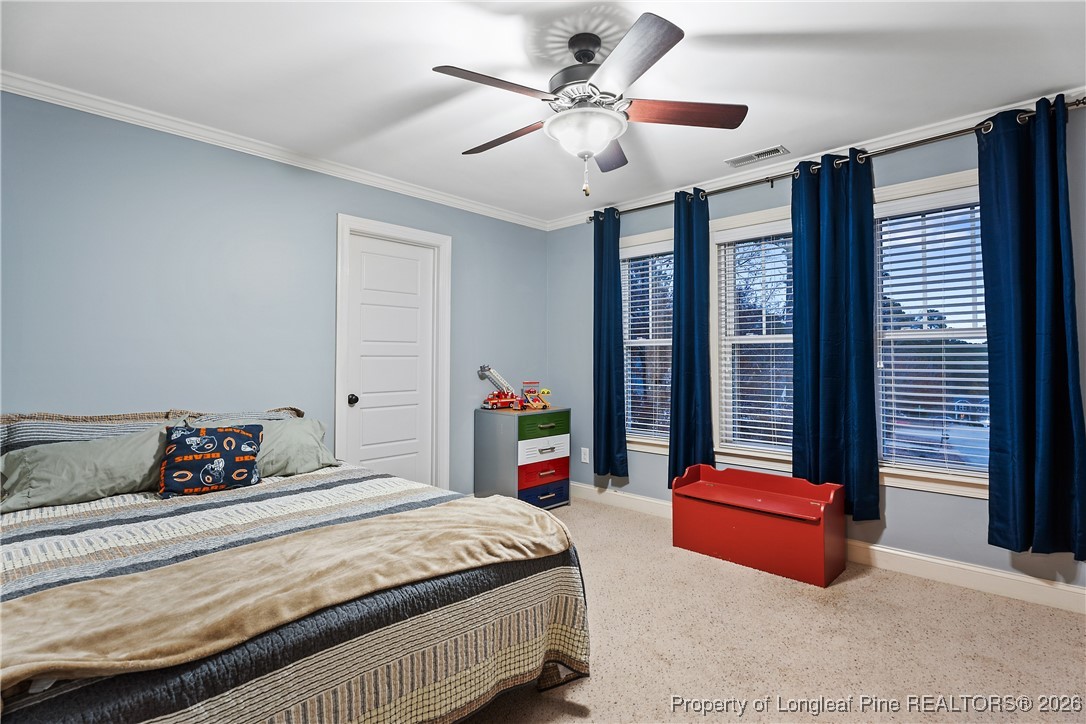38 Overview Court Spring Lake, NC 28390 - Photo 28 of 50 a bedroom with a bed and a chandelier