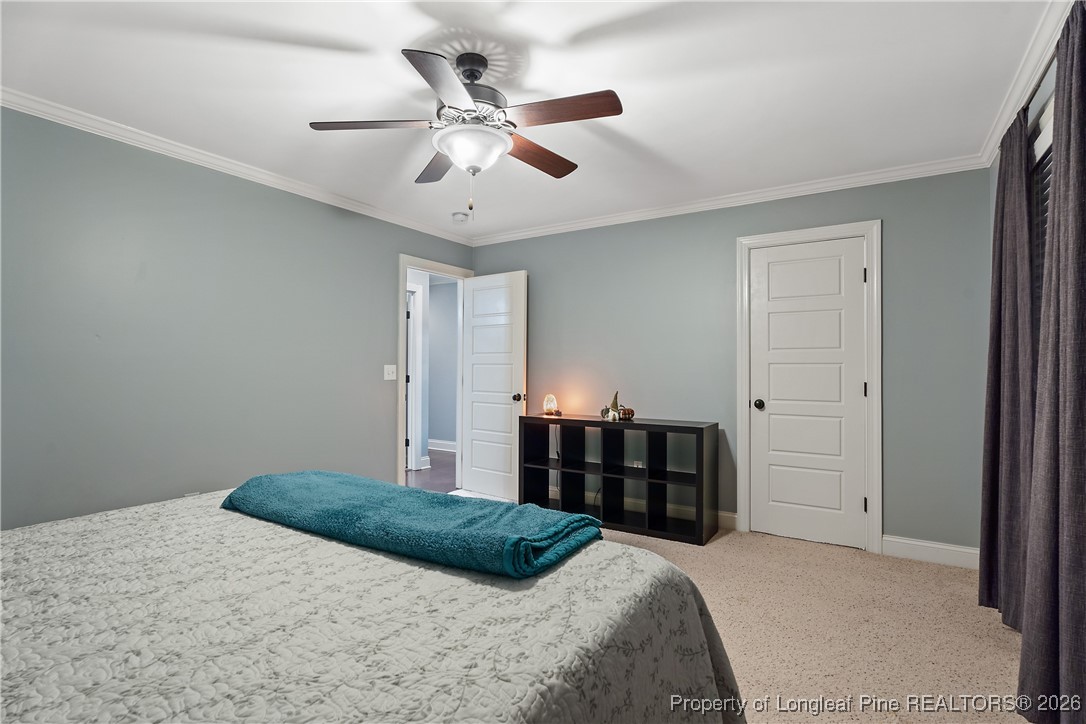 38 Overview Court Spring Lake, NC 28390 - Photo 35 of 50 a bedroom with a large bed and a chandelier