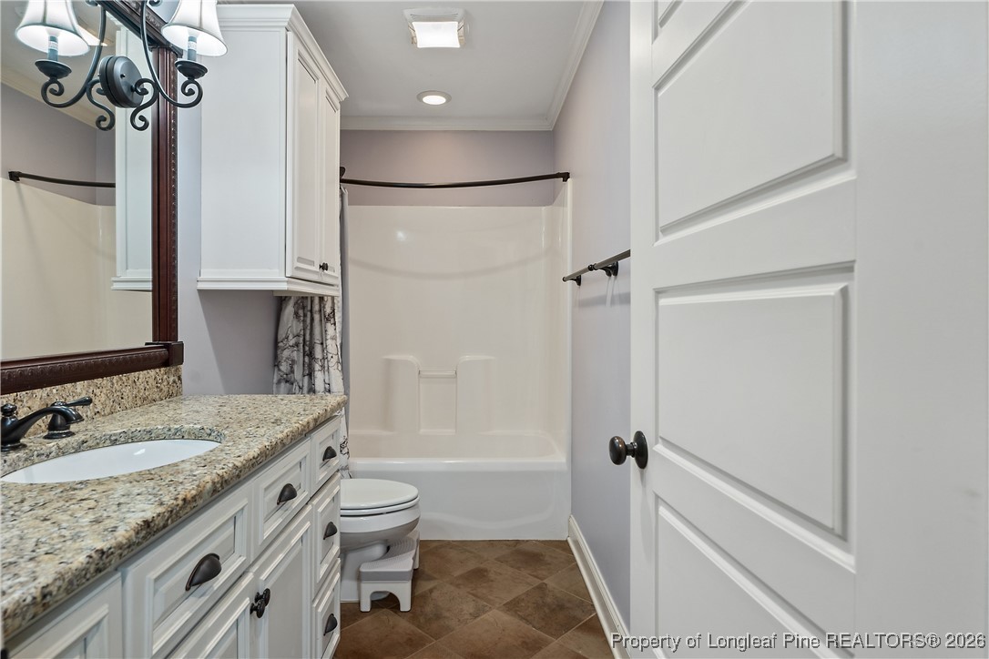38 Overview Court Spring Lake, NC 28390 - Photo 37 of 50 a bathroom with a granite countertop sink toilet and shower