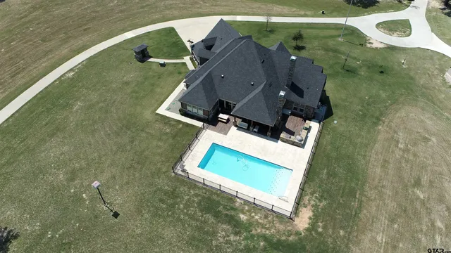 an aerial view of a house with a swimming pool