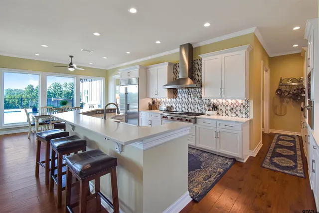 a kitchen with stainless steel appliances granite countertop a stove and a refrigerator