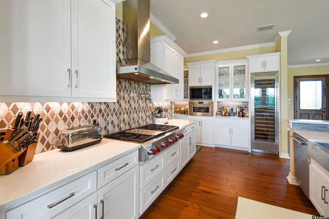 a kitchen with sink refrigerator and stove