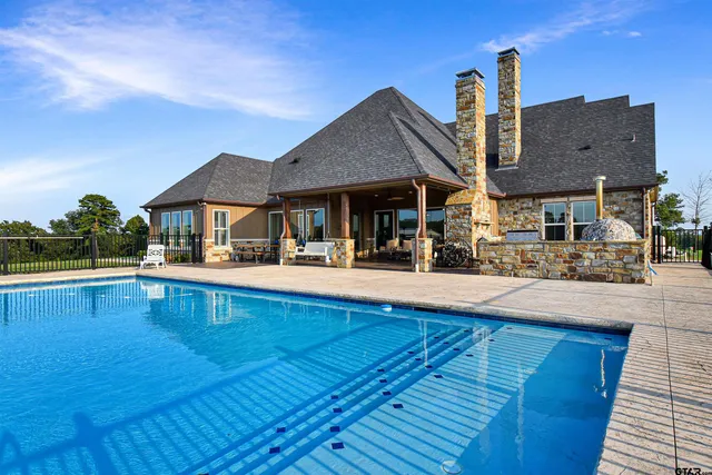 a view of a house with pool yard and outdoor seating