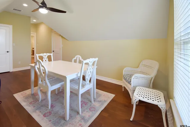 a view of a dining room with furniture and a window