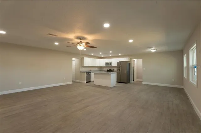 an empty room with a kitchen and a sink