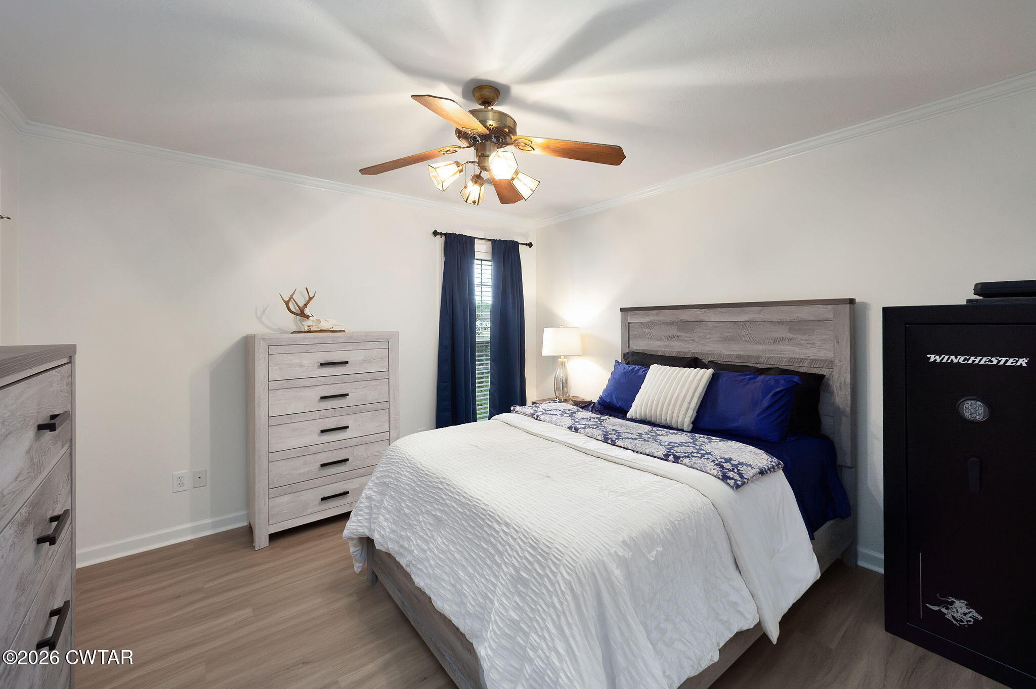 80 Rooker Drive Jackson, TN 38305 - Photo 21 of 30 a bedroom with a bed and a chandelier