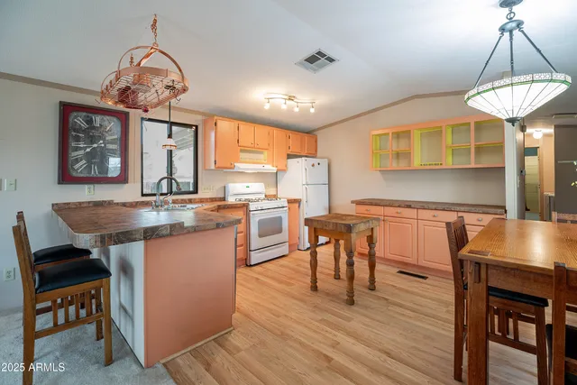 a kitchen with a sink cabinets and wooden floor