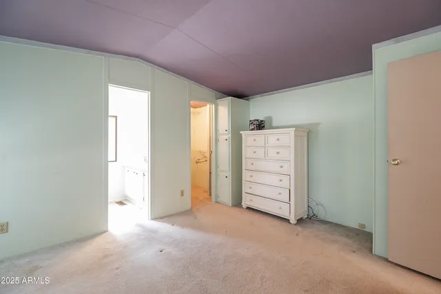 an empty room with closet and cabinet