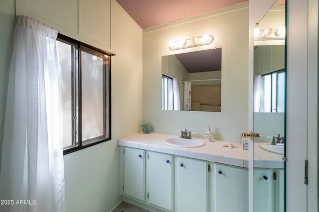 a bathroom with a double vanity sink and mirror