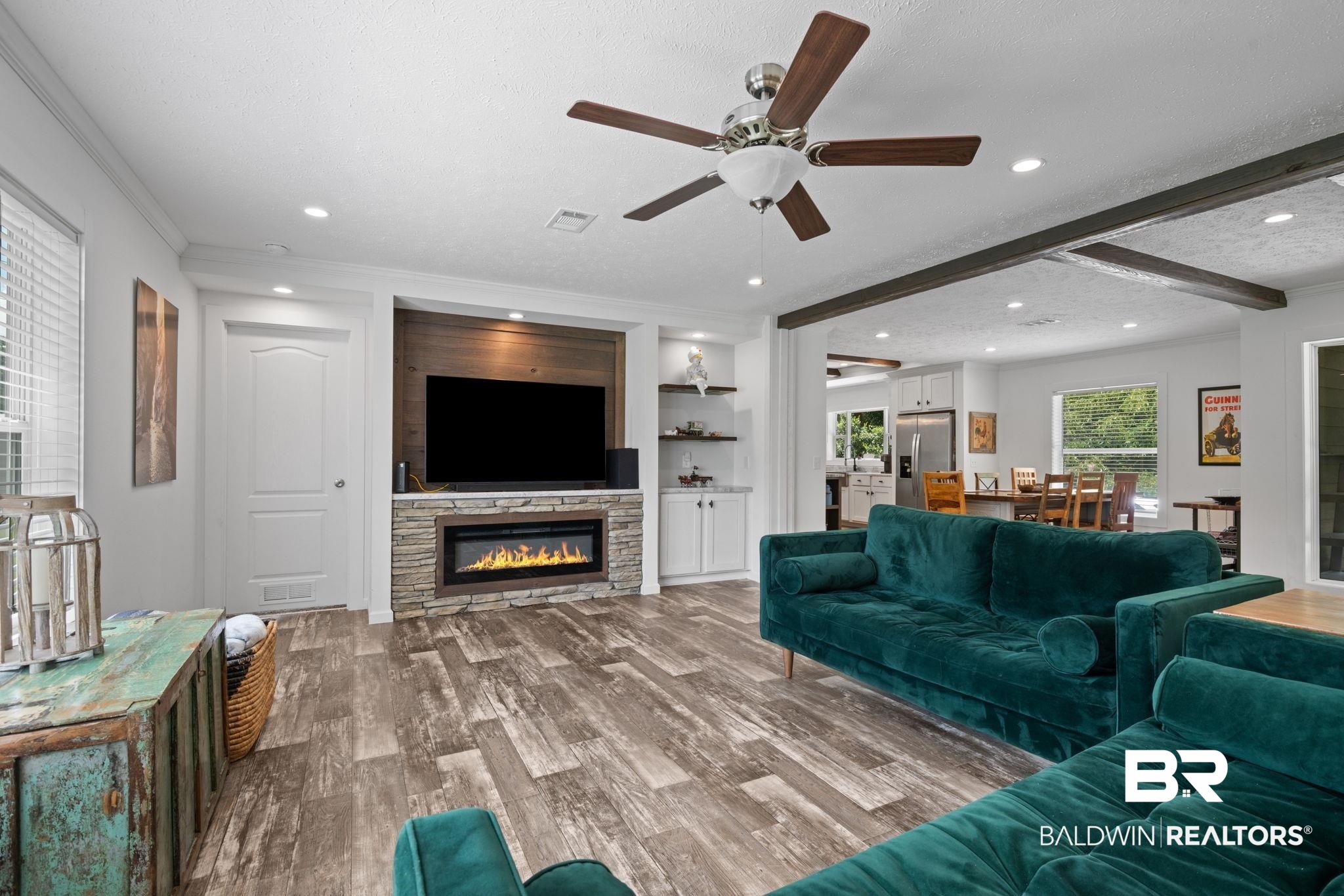 10703 South Ridge Drive Semmes, AL 36575 - Photo 17 of 37 Living room featuring a fireplace, a ceiling fan, wood finished floors, recessed lighting, and crown molding