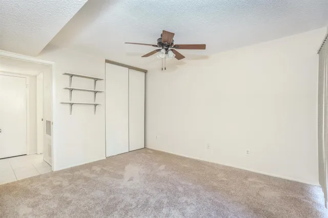an empty room with a ceiling fan