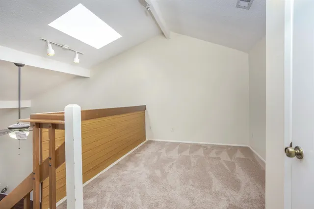 an empty room with closet and windows