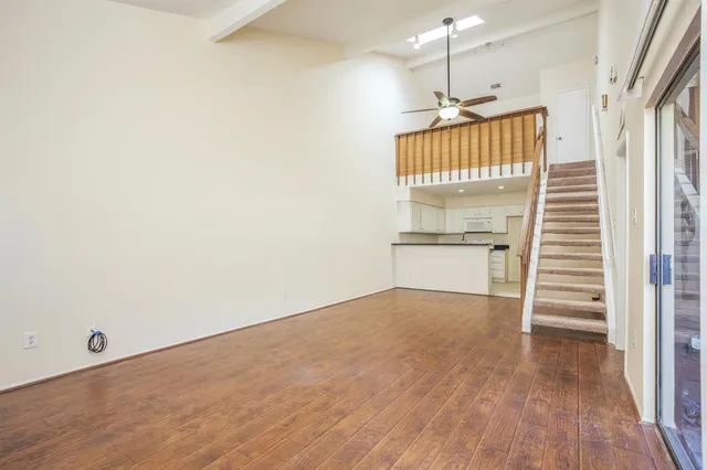 a view of a kitchen with wooden floor and a sink