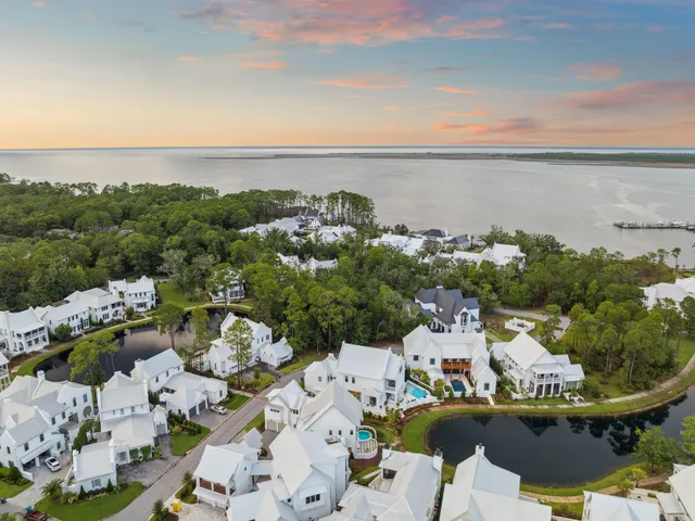 an aerial view of a houses with a lake view